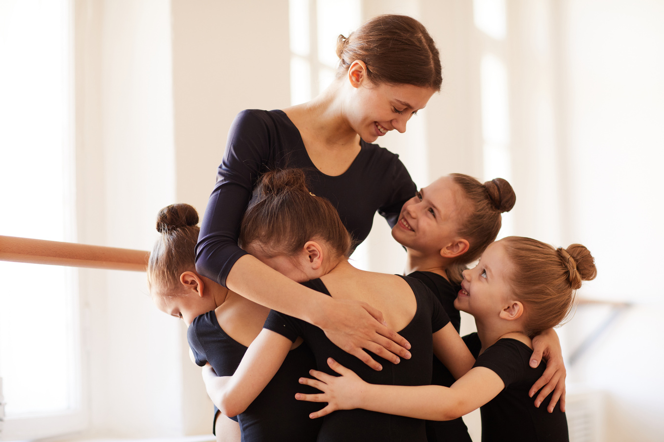 Kids Hugging Ballet Teacher